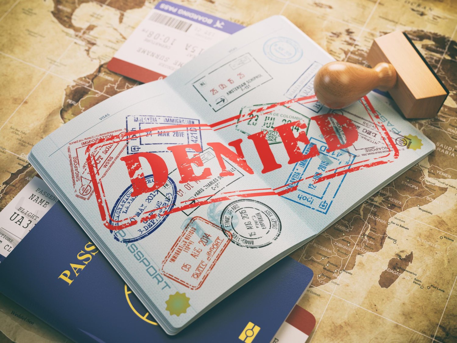 Passport stamped "DENIED," illustrating visa application rejection. Appeal pathways after visa denial.