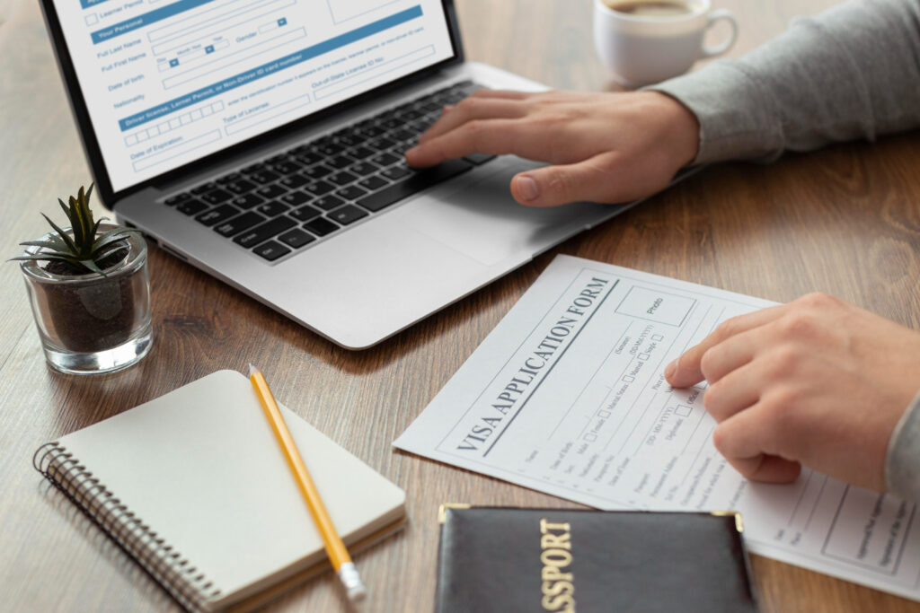 Person completing visa application form on laptop, preparing for Australian citizenship test.
