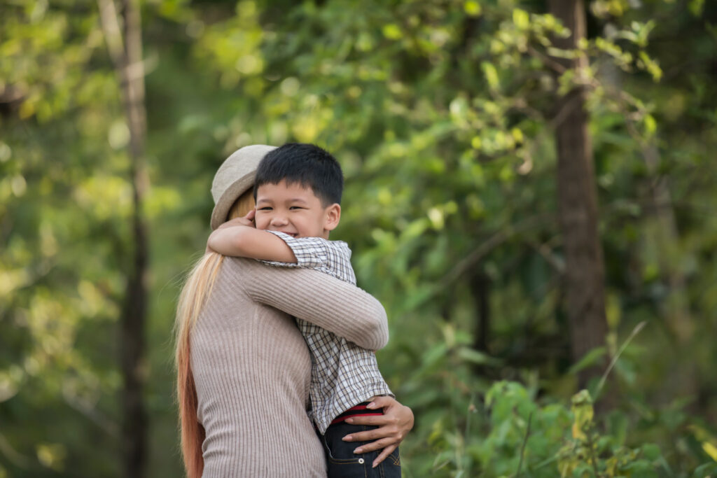 Happy mother and son embracing in a park