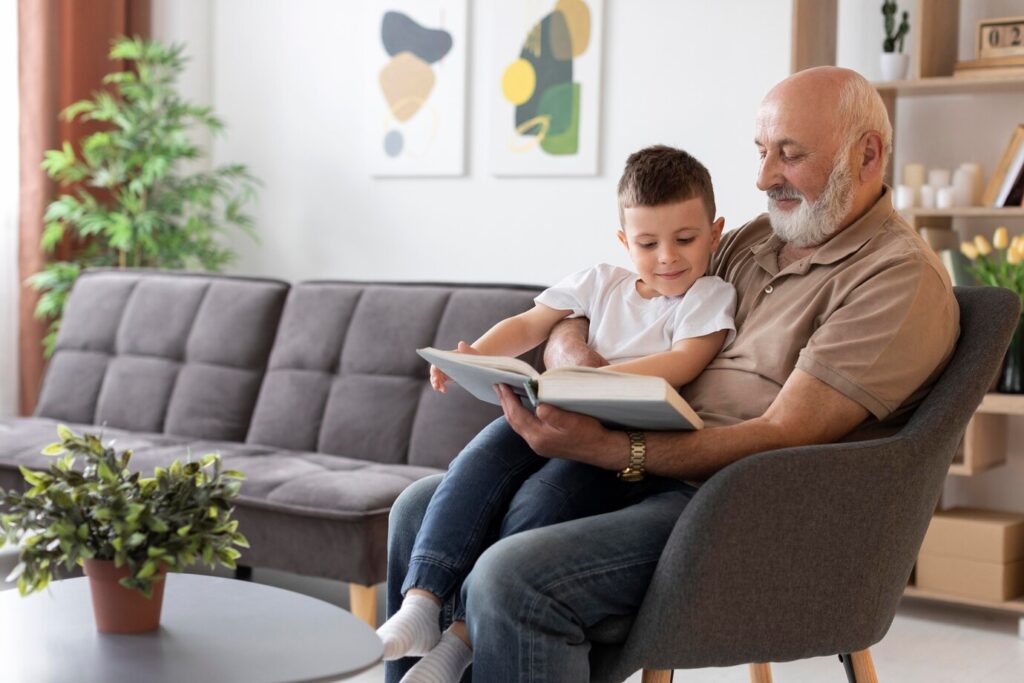 Grandfather and grandson reading a book together.