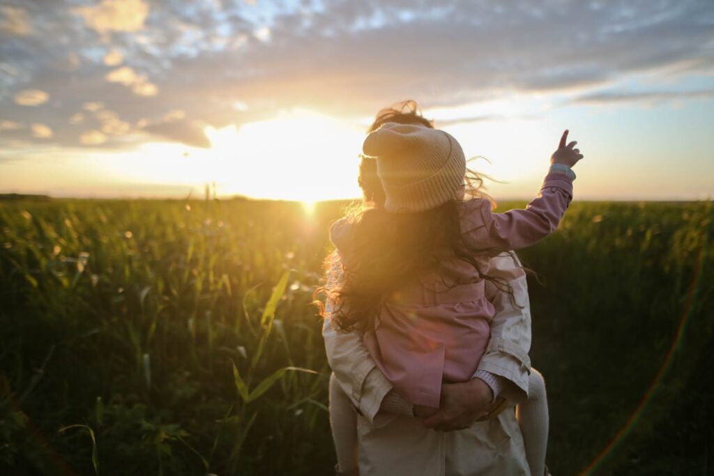 Mother and daughter enjoying sunset, applying for family visas in Australia.