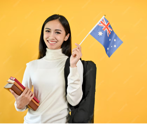 Smiling student holding Australian flag and books