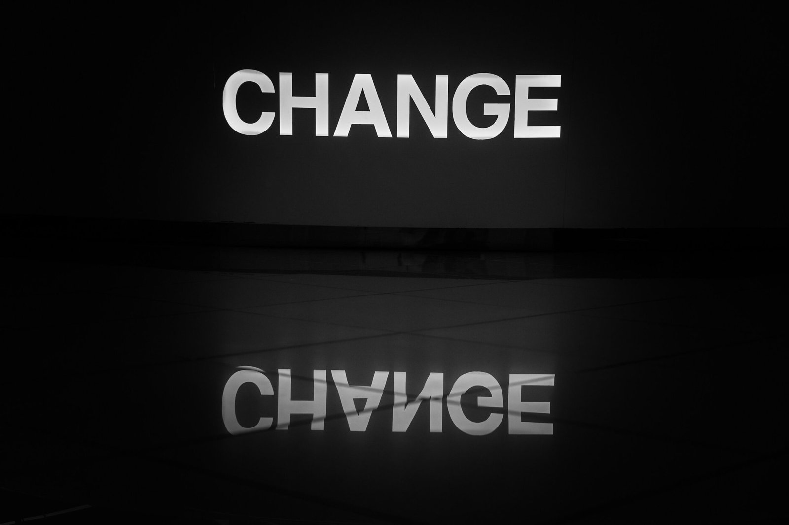 The word "CHANGE" with its reflection below.